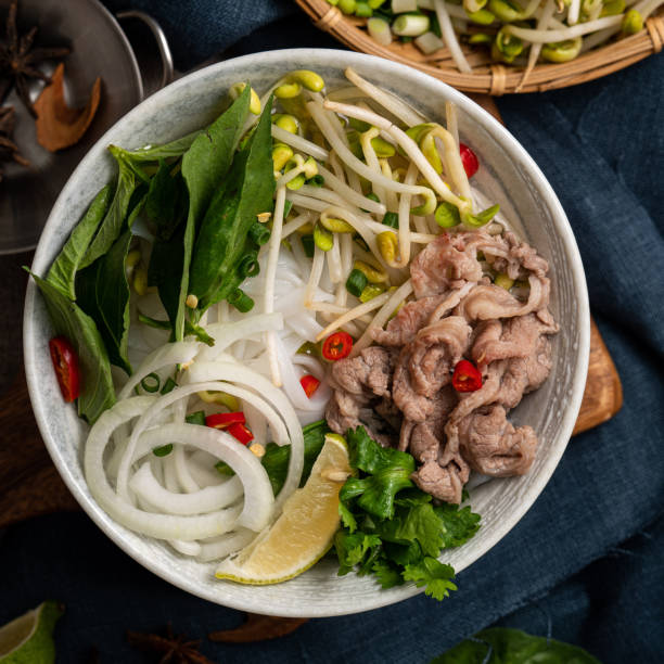 istock Delicious vietnamese beef noodles pho with ingredients. 1358719510