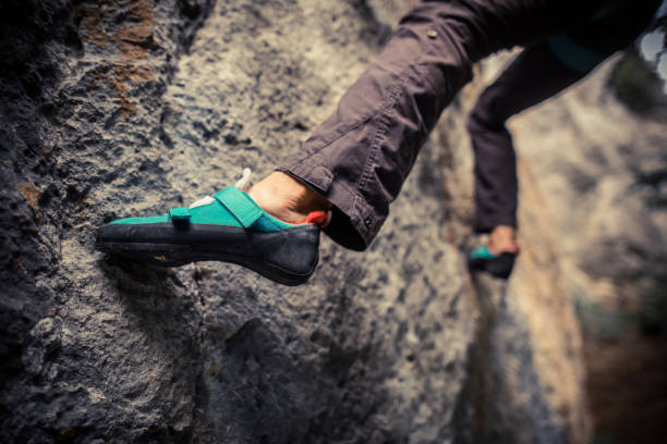 istock Person climbing while wearing rock climbing shoes 1358720249