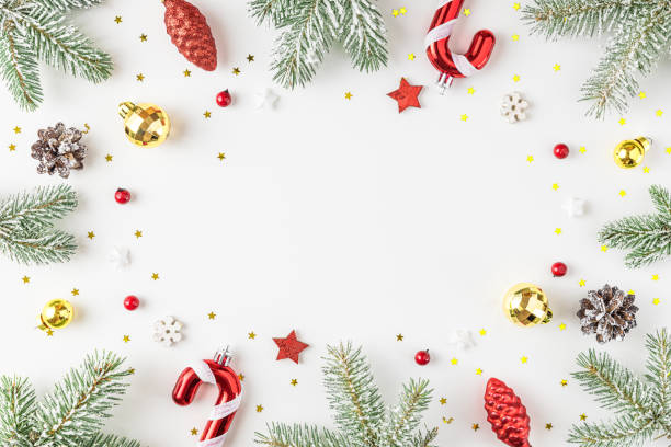 istock Christmas composition. Frame made of fir tree, festive decorations, red berries on white background. Flat lay. 1358723040