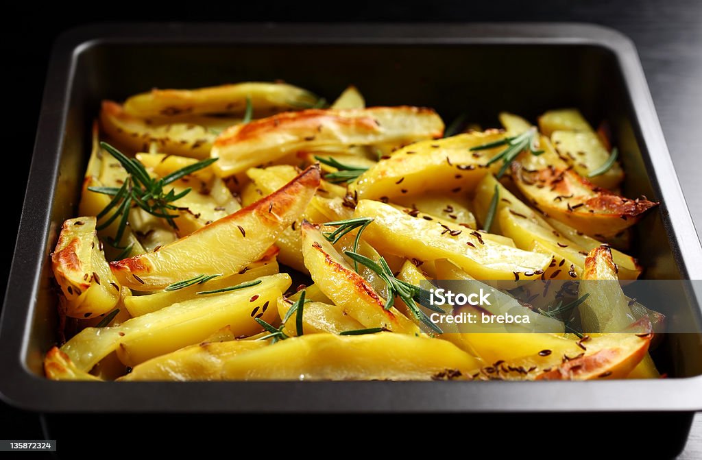 Baked potatoes Baked potatoes with rosemary in casserole Baked Stock Photo