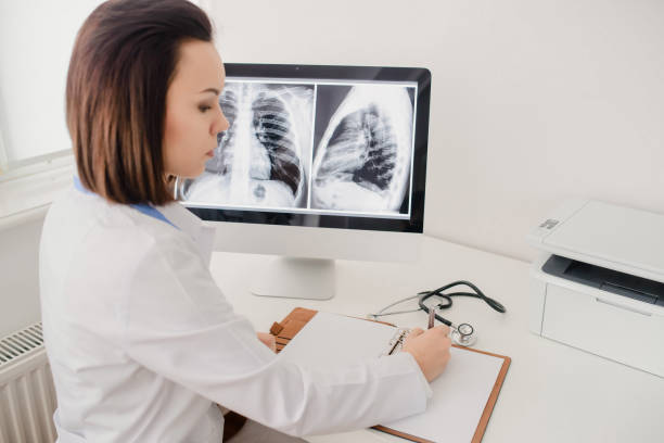 istock Young woman radiologist doctor analysis x-ray 1358724210