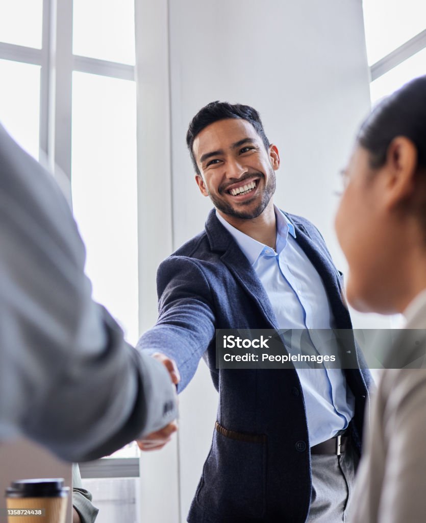 Shot of two business people shaking hands during a meeting Pleased to meet you Handshake Stock Photo
