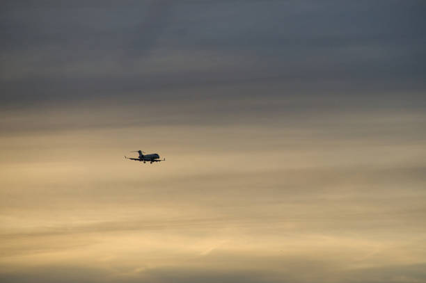 istock airplane in the evening sky in luminous horizon. 1358724928