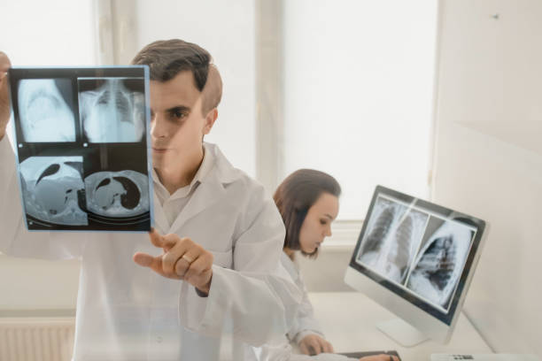 istock In medical room two young doctors radiologists analyzing x-ray 1358724969