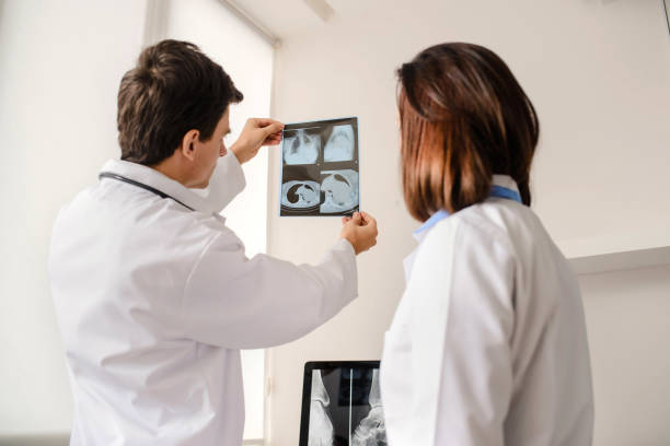 istock In medical room two young doctors radiologists analyzing x-ray 1358725481