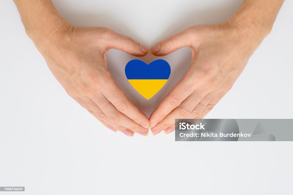 The national flag of Ukraine in female hands. The concept of patriotism, respect and solidarity with the citizens of Ukraine The national flag of Ukraine in female hands. The concept of patriotism, respect and solidarity with the citizens of Ukraine. Ukraine Stock Photo