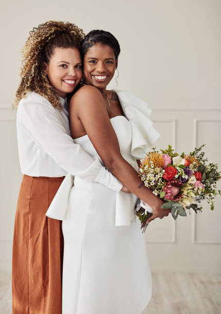Shot of a young lesbian couple standing together and posing after getting married Here's to forever with you indian bridal hairstyles stock pictures, royalty-free photos & images