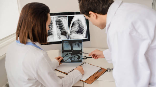 istock Back view of young doctors radiologists analises x-ray 1358726092