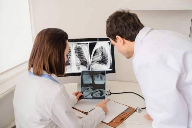 istock Back view of young doctors radiologists analises x-ray 1358726184
