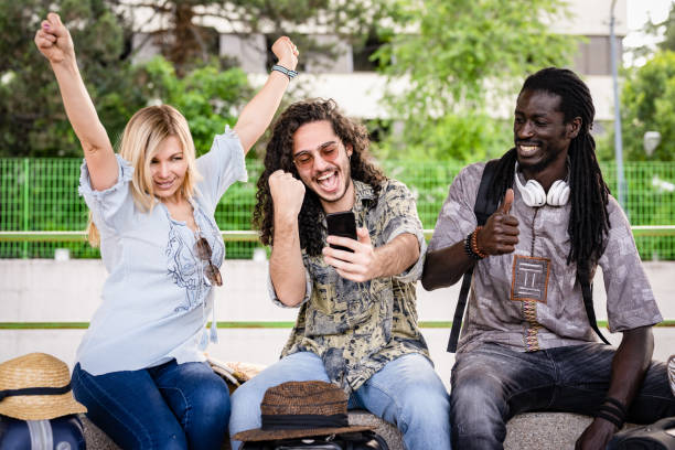 three people from diverse ethnies and culture travelling with train, happy friends using smartphone and technology for travelling around the world