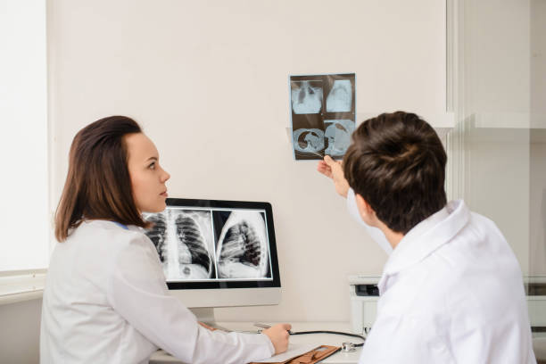 istock Back view of young doctors radiologists analises x-ray 1358726224