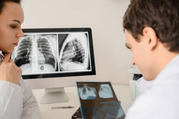 istock Back view of young doctors radiologists analises x-ray 1358726321