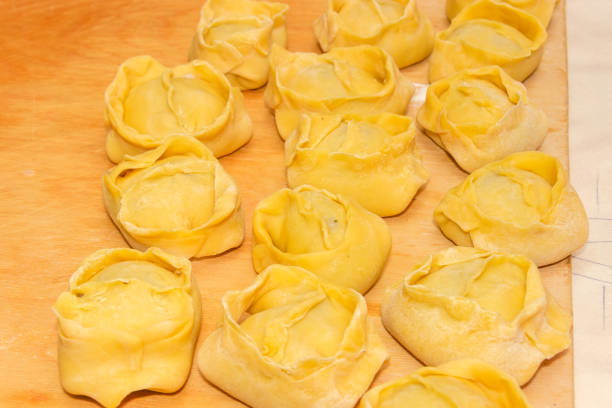 istock Uncooked manti on cutting board, prepared to boiling or steaming 1358727376