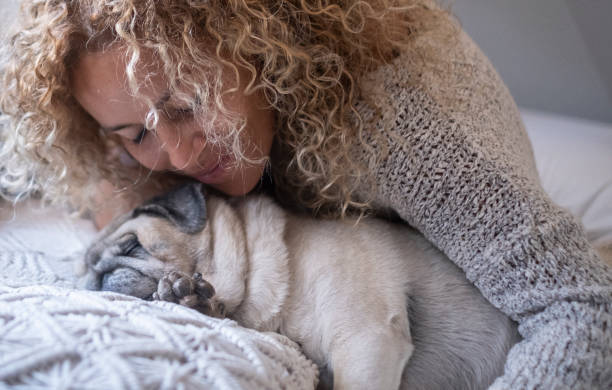 istock Woman Embracing Dog At Home 1358728340