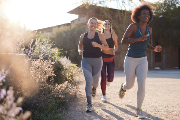istock A group of women runs outdoors on a spring day. 1358730699