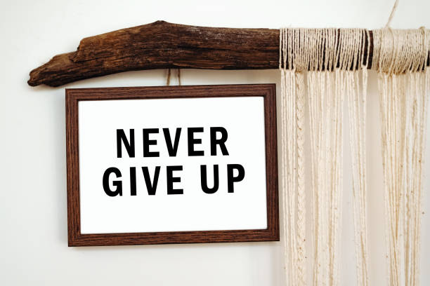 istock The words Never give up written on a white paper. Motivation concept 1358731101