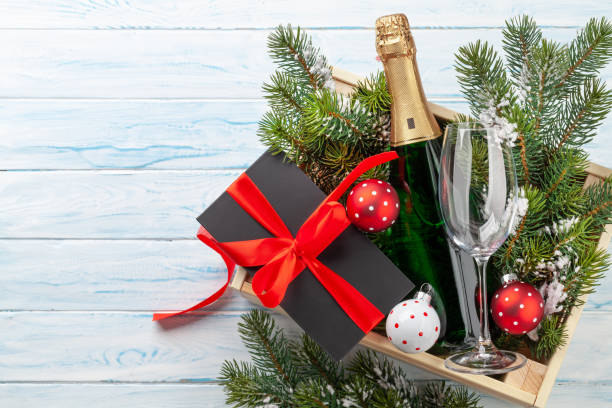 istock Christmas gift box with champagne bottle 1358731345