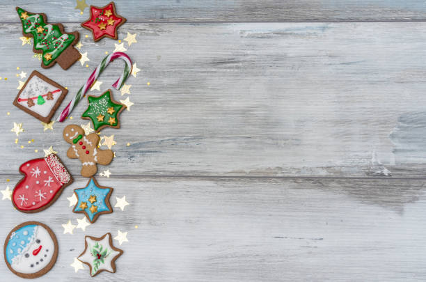 istock Festive white rustic signboard, left side decorated with Christmas homemade cookies. Idea for party invitation, cards, wishes 1358731349