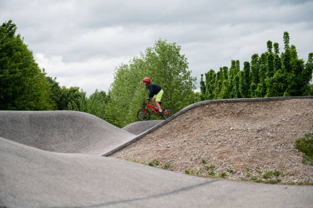 istock Boy riding a bike on a pump track 1358732383