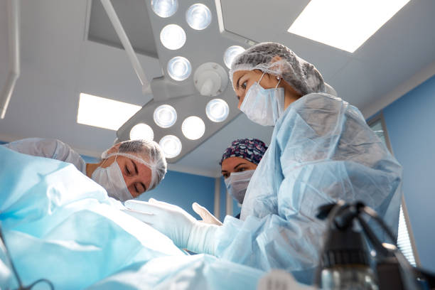 istock Concentrated Surgical team operating a patient in an operation theater 1358732788