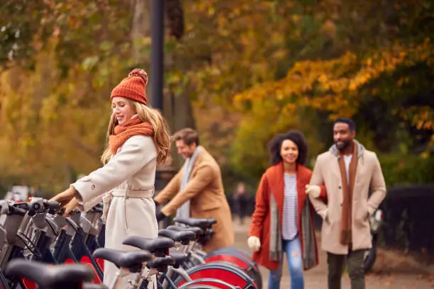 Photo of People Hiring Bikes As Green Form Of Transport To Get Around City In Autumn Or Fall