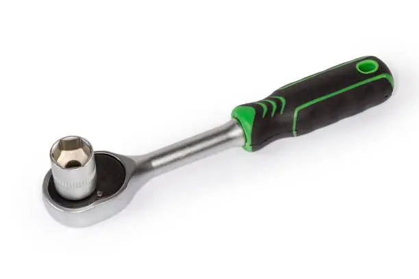 Photo of Ratchet wrench with inserted hexagonal socket on a white background