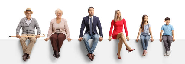 una famiglia di tre generazioni seduta su un pannello bianco e sorridente alla telecamera - grandmother child grandparent isolated foto e immagini stock