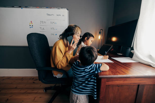istock Working mother taking a phone call in her home office 1358737204