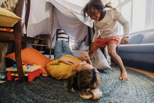 istock Active little girl playing with her mom at home 1358737297