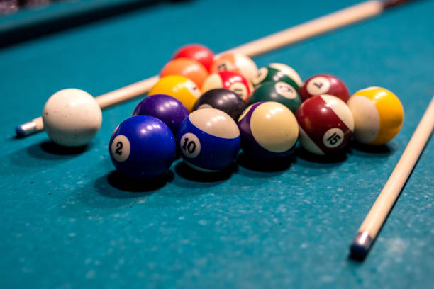 istock Billiard balls in a green pool table, ready for recreational activity 1358737878