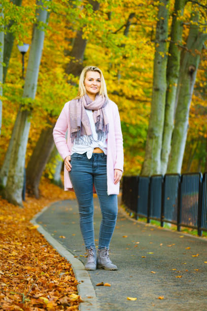istock Woman walking in autumn park 1358738737