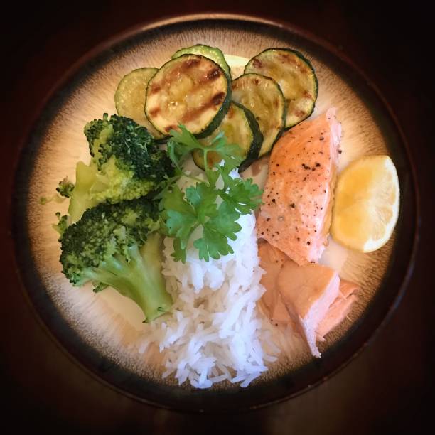 istock Poached salmon with white rice courgettes and broccoli 1358738935