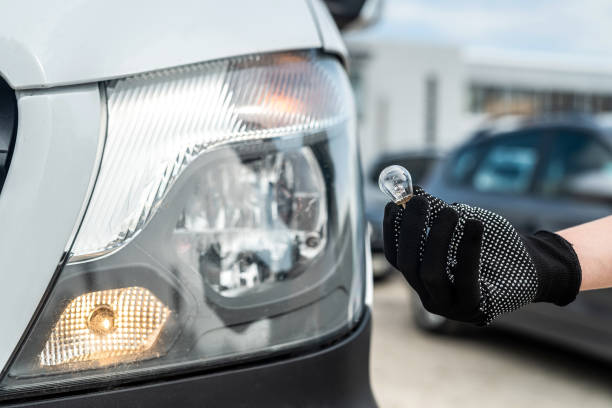 istock manual worker is changing a light bulb of the car 1358740399