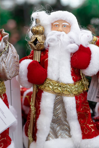 istock Santa Claus on the store shelf in red suits 1358741702