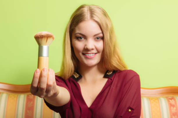 Young attractive pretty woman girl holding powder brush. Fashion and make up.