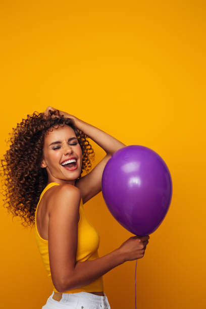 istock Beautiful woman holding a balloon 1358742992