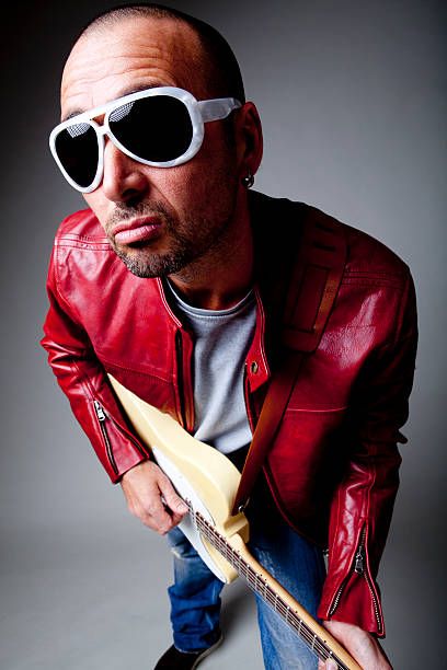 istock musician with glasses play guitar in studio 135874346