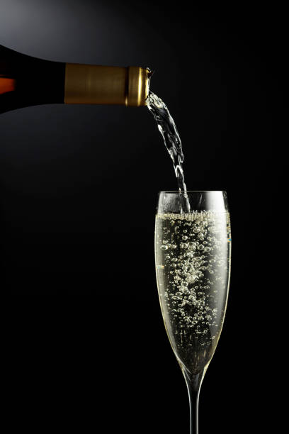 istock Sparkling wine is poured from a bottle into a glass. 1358743514
