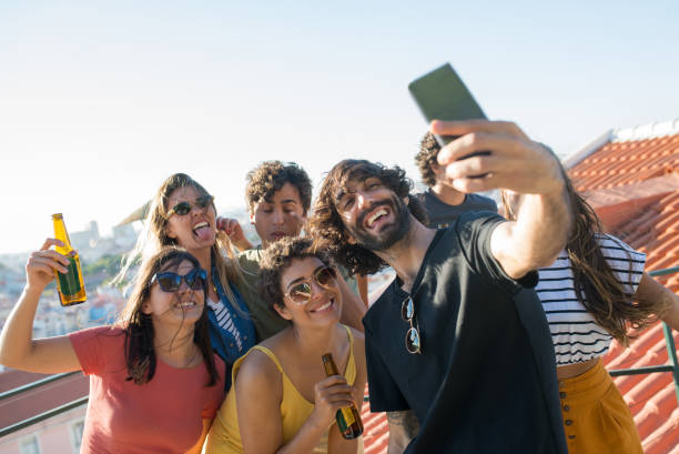 istock Pleased friends taking selfie at party 1358743948