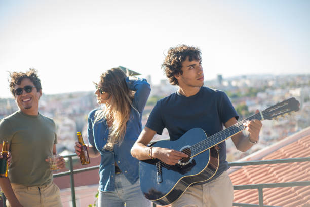 istock Handsome young man playing acoustic guitar 1358744145