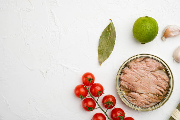 istock Canned tuna fish, on white stone table background, top view flat lay, with copy space for text 1358744731