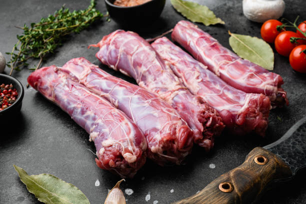 istock Fresh raw duck neck without skin, on black dark stone table background 1358744818