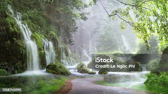 istock Many waterfalls flowed with plastic roads in the forest - art landscape paintings 1358745090