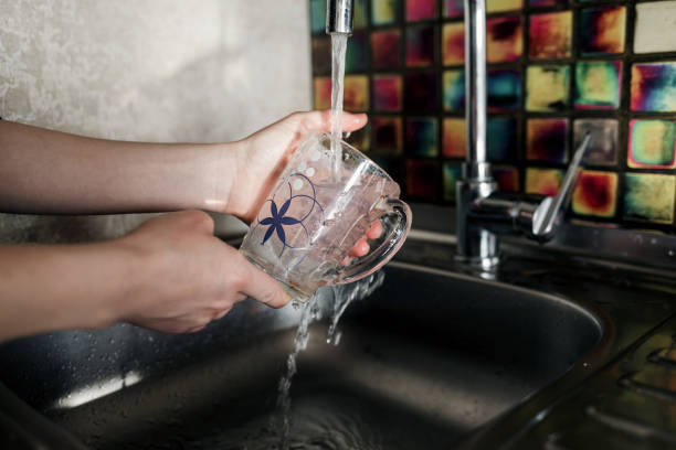 istock women's hands washing a mug 1358745129