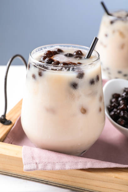 istock Bubble milk tea with tapioca balls on table against blue background 1358745176