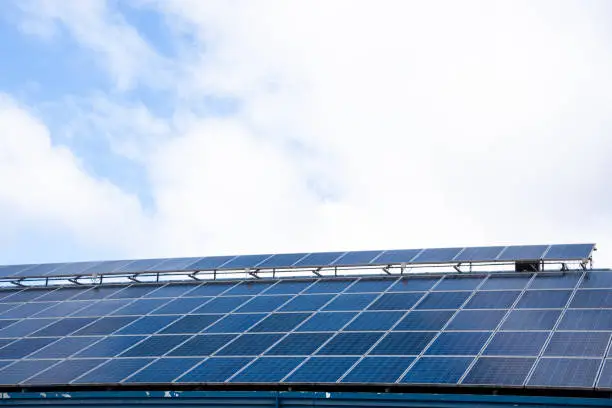 Detail of a set of solar panels on the roof of a house on a day with blue sky