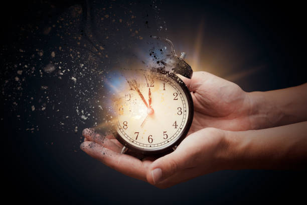 istock Concept of passing away, the clock breaks down into pieces 1358746173