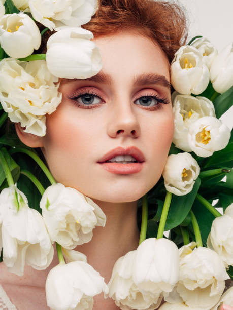 istock Beautiful girl with tulips 1358746235