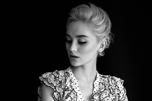 Beautiful blond European teenage girl, black and white close up outdoor portrait
