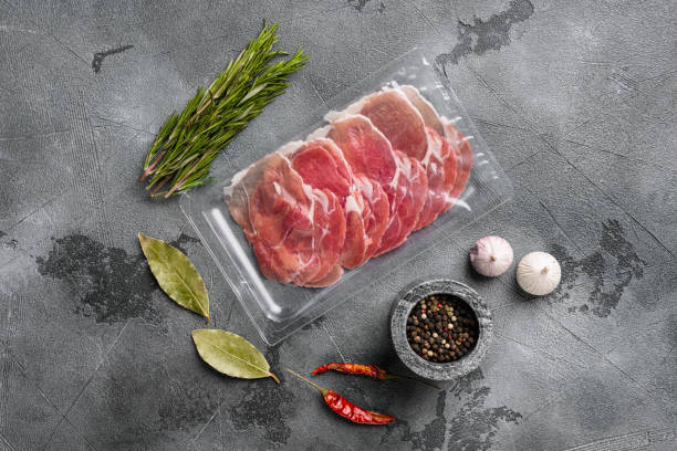 istock Vacuum packed serrano ham, on gray stone table background, top view flat lay 1358746526